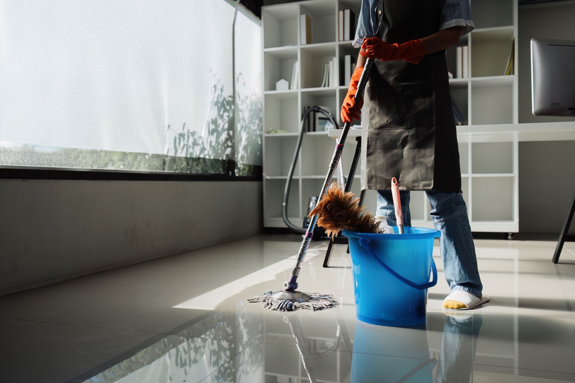 Female housekeeper smile and wearing glove, preparing to clean office